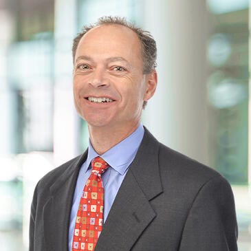 a man in a suit smiling