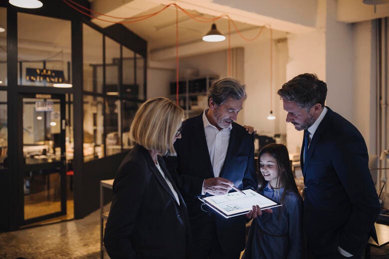 a group of people looking at a paper