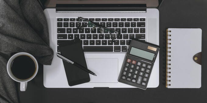 a laptop and a phone on a table