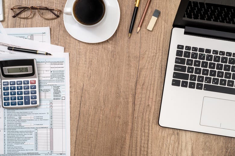 a desk with a laptop and a cup of coffee