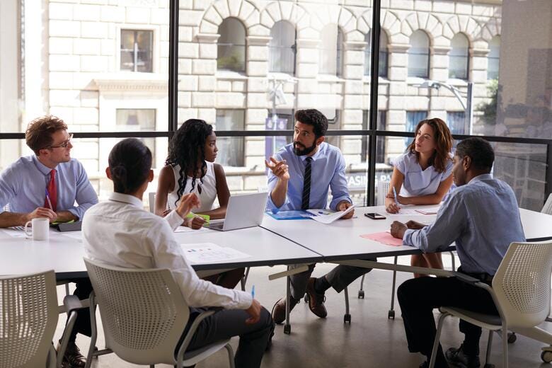 a group of people sitting around a table